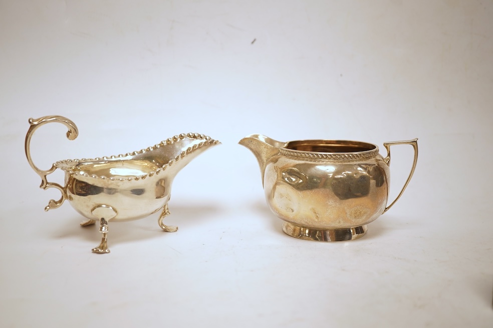 A small quantity of assorted silver including a Victorian sauceboat, London, 1851, length 12.6cm, a sugar bowl, a tea strainer on stand, mustard pot and ladle, three mounted brushes, a salt, pieced bonbon dish and a case